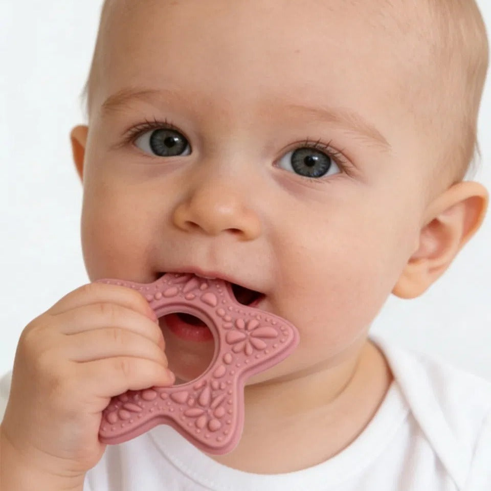 Baby chewing Snuglet starfish teether